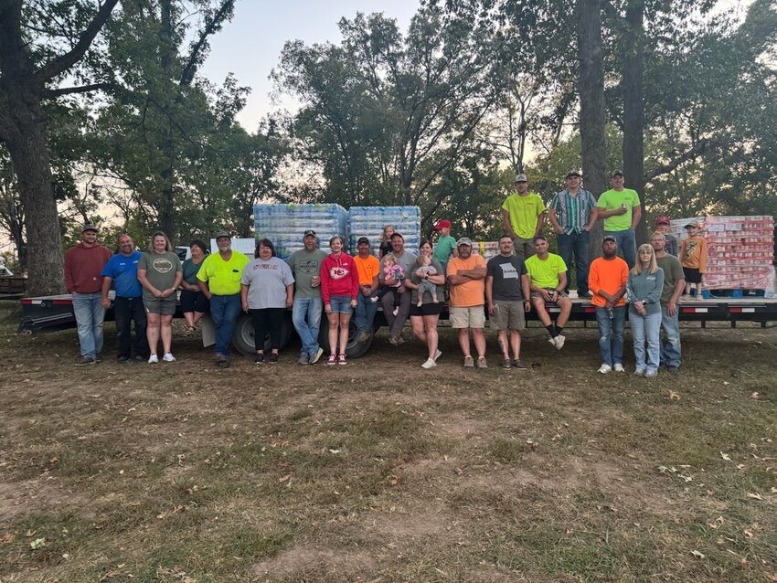 Aaron and Jessica Kempker, members of Our Lady of the Snows Parish in Mary&rsquo;s Home, gather with their children and a group of friends in front of one of the flatbed trailers they helped load up with donated necessities for Mr. Kempker to deliver to hurricane-ravaged Erwin, Tennessee.
