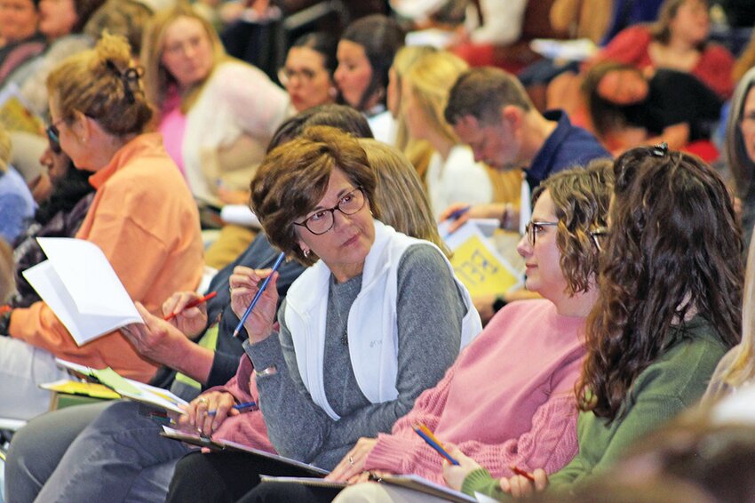 Teachers exchange their answers to discussion questions during the diocese&rsquo;s annual Teachers&rsquo; Professional Development Day March 7 in Columbia.
