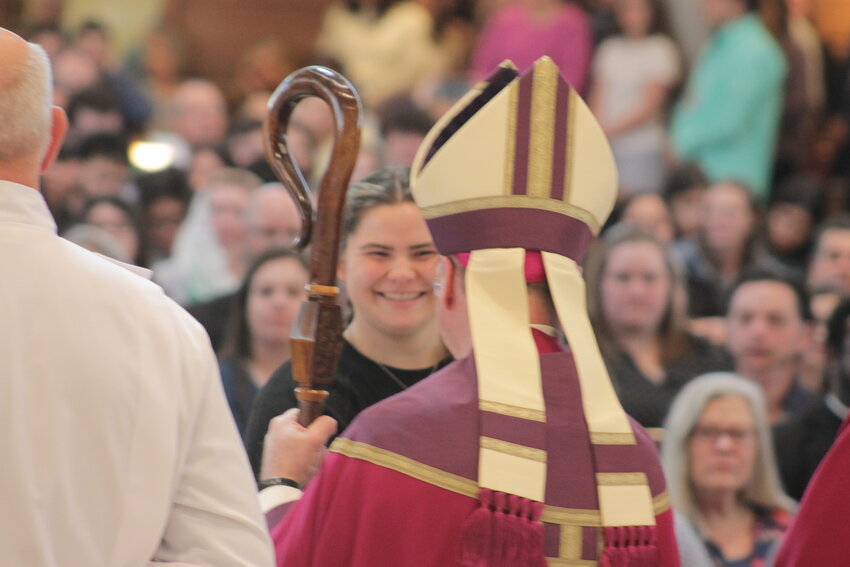 Bishop W. Shawn McKnight greets a woman preparing to receive Sacraments of Initiation at the Easter Vigil, during the Rite of Election and Call to Continuing Conversion, on March 9 in the Cathedral of St. Joseph.
