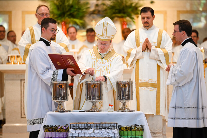 Archbishop-designate W. Shawn McKnight mixes fragrant balsam with the Oil of Sacred Chrism while consecrating it for sacramental use, during this year&rsquo;s Chrism Mass April 15 in the Cathedral of St. Joseph.