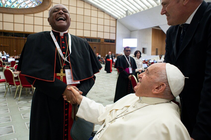 Cardinal Wilton D. Gregory of Washington shares a laugh with Pope Francis before the first working session of the assembly of the Synod of Bishops Oct. 4, 2023, in the Paul VI Audience Hall at the Vatican. (CNS photo/Vatican Media)