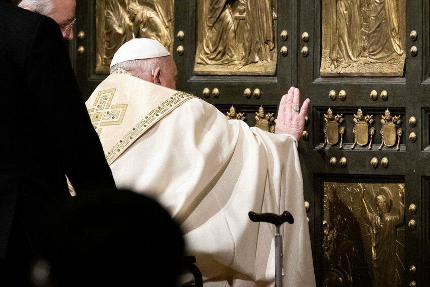 Pope Francis pushes open the Holy Door of St. Peter's Basilica at the Vatican Dec. 24, 2024, inaugurating the Holy Year 2025.