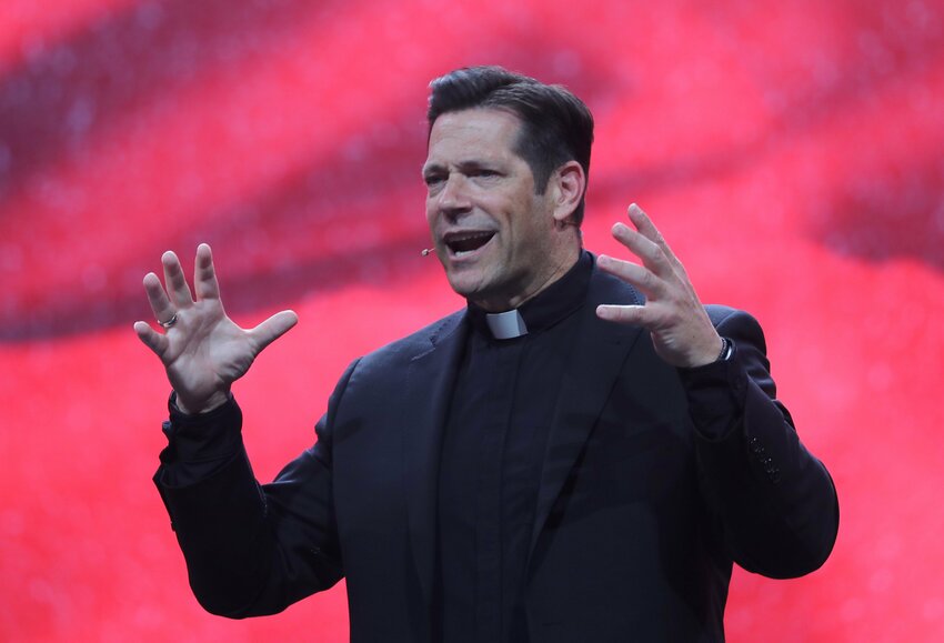 Father Mike Schmitz, a priest of the Diocese of Duluth, Minn., and host of the Bible in a Year podcast, speaks during the July 18, 2024, second revival night of the National Eucharistic Congress at Lucas Oil Stadium in Indianapolis.