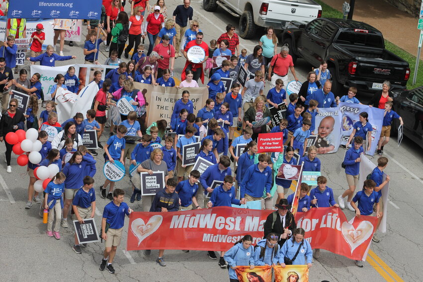St. Stanislaus School students carry the banner at the front of this year&rsquo;s MidWest March for Life in Jefferson City.