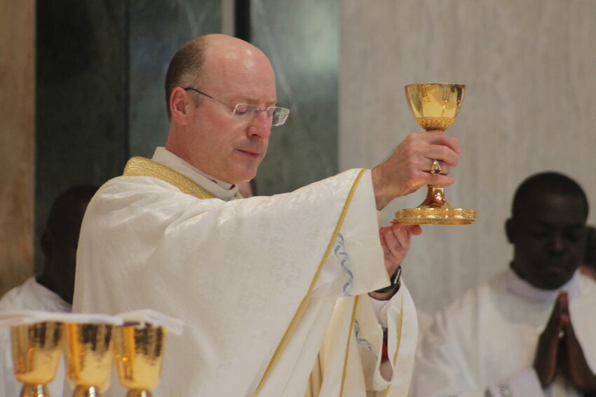 Archbishop Shawn McKnight elevates the Most Precious Blood at Mass in the Cathedral of St. Joseph.