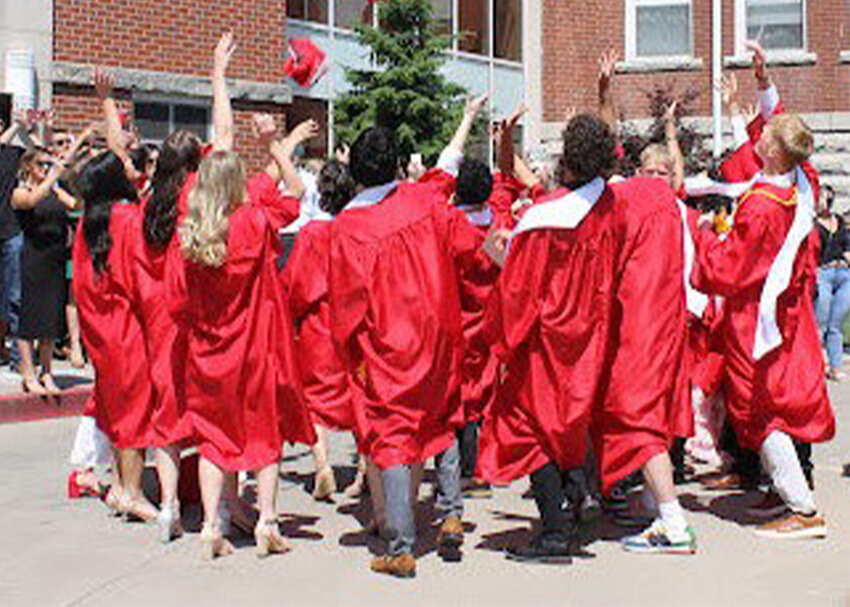 Members of Sacred Heart High School&rsquo;s Class of 2025 toss their mortarboards high over Circle Drive following the school&rsquo;s 81st commencement ceremony.