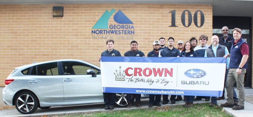 Subaru1 &ndash; GNTC Automotive Technology instructor Troy Peco (far right) and his students on the Walker County Campus pose with a banner to thank Subaru representatives for the donation of a 2019 Subaru Impreza. From left are students Isaiah Lewis, Isidro Tapia, Miguel Pardo, Gavyn Peace, Eber Calzada, Alex Leon, Shelby Tapley, Luis Rodriguez and Jason Gonneville; Brent Roberts, district parts/service manager for Subaru of America Inc., and Desmond Hagan, fixed operations director for Crown Subaru in Chattanooga.