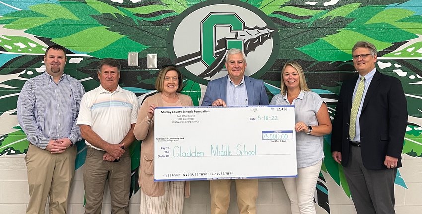 Contributed photos  A ceremonial check was recently presented by the Murray County Schools Foundation to Gladden Middle School. Pictured are (from left) Matt Bryson (assistant principal)  Johnny Waters (MCS board member) Phenna Petty (board member), Steve Loughridge (superintendent) Daphne Winkler (GMS principal) and Chad Pannell (board member.)