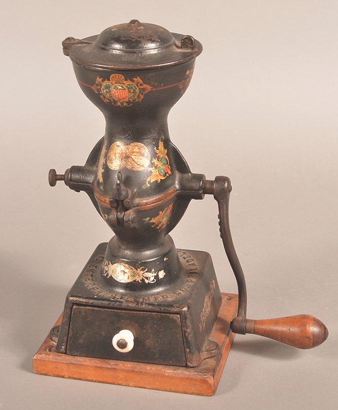 This strange looking cast-iron tool is a coffee grinder. Beans go in the top, the lid is put in place and the beans are ground and drop into the lower section mounted on a wooden base.