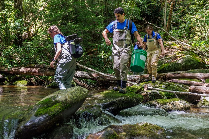 Reintroduction Assistant Kaylee Clayton, left, Jim Hill Fellow for Conservation Anthony Hernandez, center, and Reintroduction Biologist Teresa Israel cross a stream during a Southern Appalachian Brook Trout release.