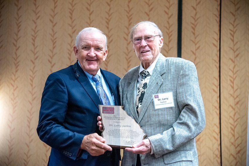 Georgia Farm Bureau President Tom McCall, left, presents Dr. Larry Guthrie the Georgia Farm Bureau Commodity Award.