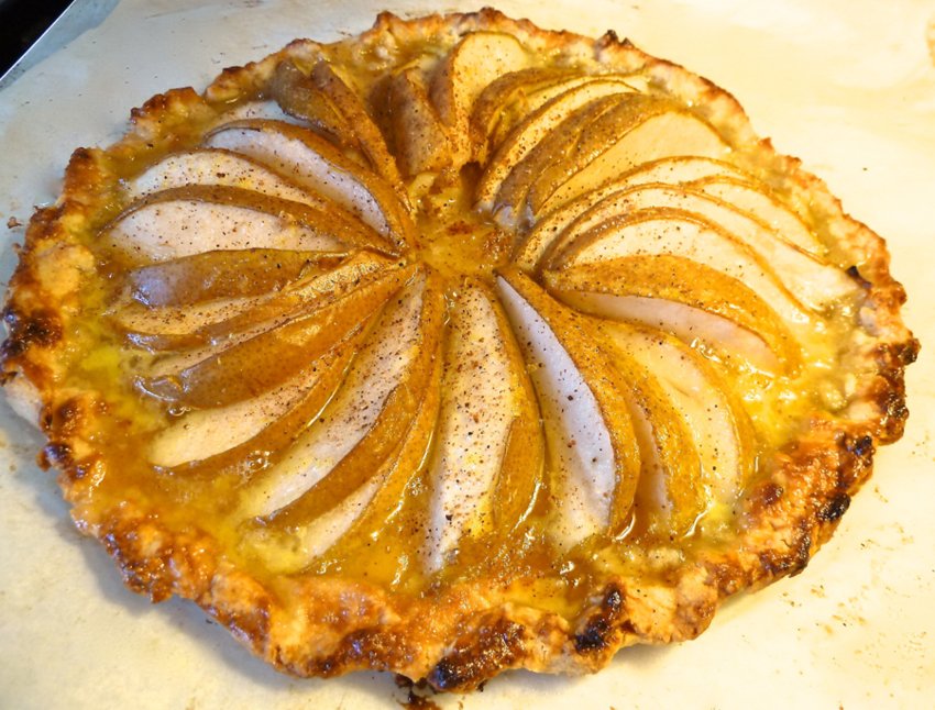A tasty, handmade rustic pear galette is ready to serve.
