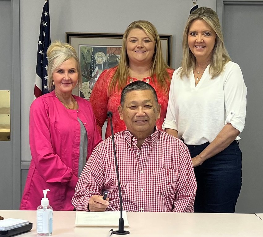 Mayor K.W. Gong of Chatsworth signs October is Cancer Awareness Month Proclamation. With him are Karen Penland, Christy Nation, and Cathy Dodd of the Murray County Health Department.