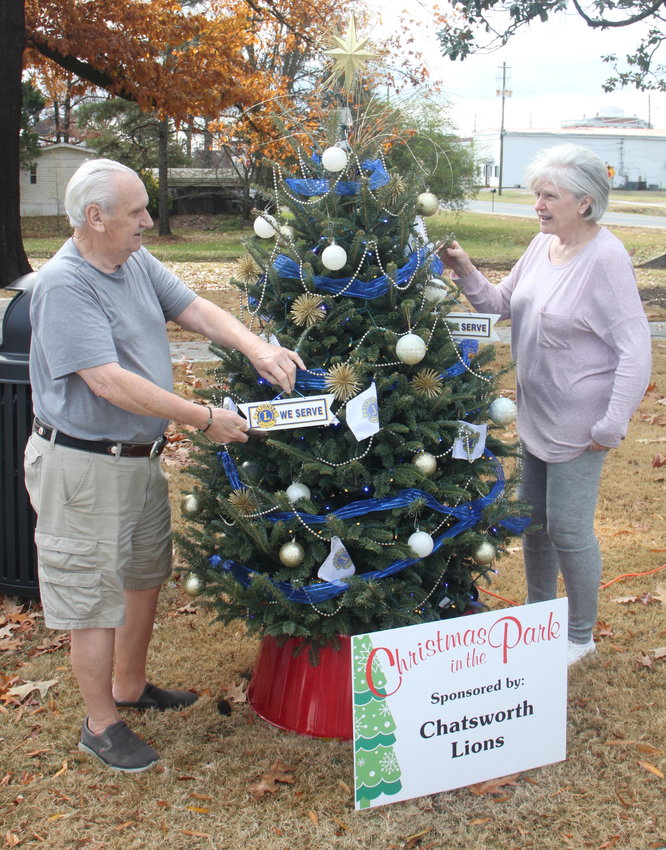 Lions Club members Kenneth and Ellen Moore check out the club tree at Chatsworth City Park, More than 100 trees have been decorated in advance of Christmas in the Park, which starts today at 5 p.m.