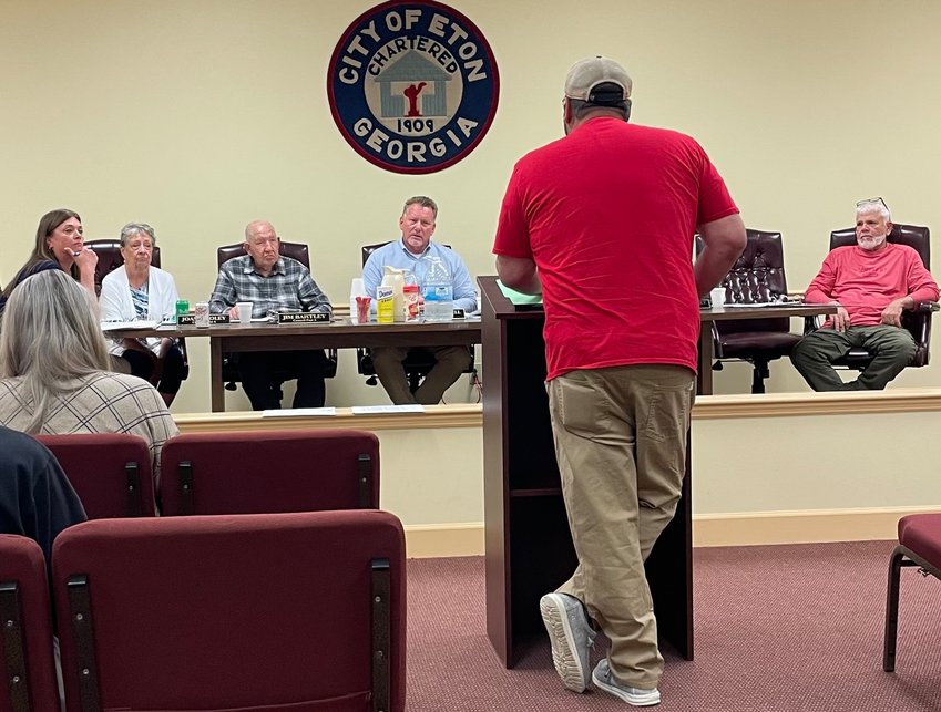Eton part-time firefighter Josh Cherry (back to the camera) tells the city council and mayor his concerns with their decision to close the city&rsquo;s fire department.