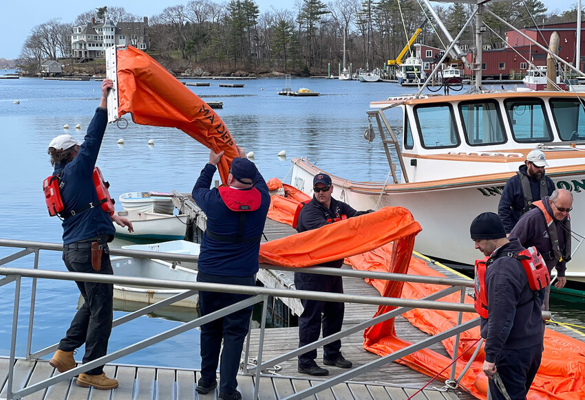 Cape Ann Fire and Police officers and MBTS Harbormaster Bion Pike (far left) trained at Masconomo Park last Wednesday morning on oil spill response.