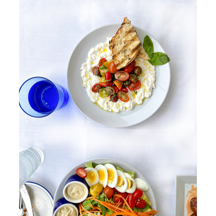 The Caprese Fantastica (above) with burrata stracciatella, organic cherry tomatoes, and grilled Virgilios ciabatta is a popular new menu item, but the Cobb Salad (below) is a loved staple.