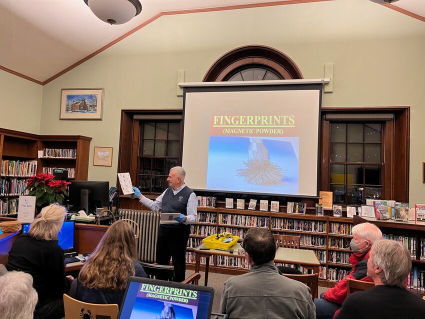 Massachusetts State Police Crime Lab veteran Paul Zambella dusts for attendees'
 fingerprints at his Forensic Science Roadshow program, which drew a crowd of mystery fans and others with a CSI affinity to the Manchester-by-the-Sea library last week.