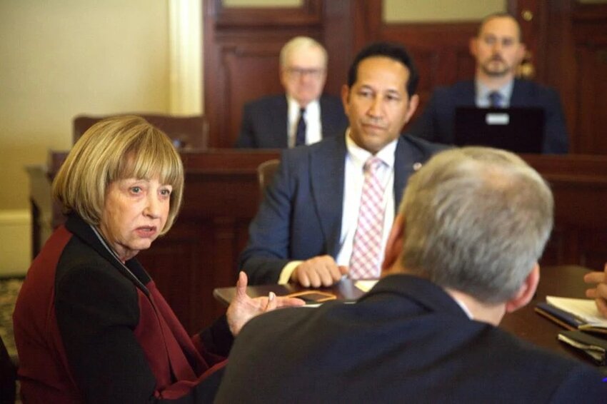 Sen. Cindy Creem talks to Sen. Bruce Tarr about a vote to close meetings between the conference committee tasked with negotiating a major gun control reform bill to the public. Creem voted alongside other Democrats to keep the negotiations private, while Tarr (right, bottom), a Republican, and Republican Rep. Joseph McKenna dissented.