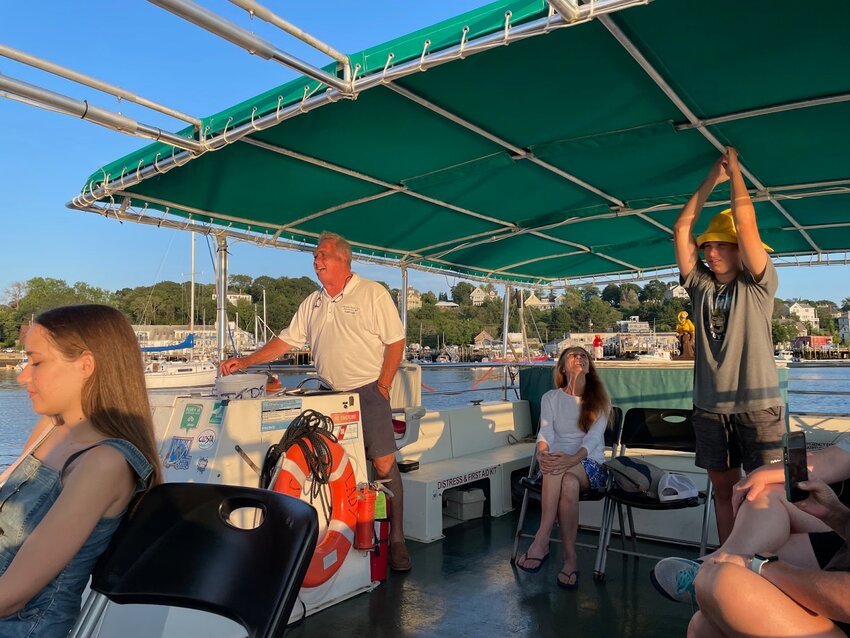 Captain Steve Douglass of Cape Ann Harbor Tours shuttling “Splashers” to cultural events on Rocky Neck and in Harbortown, 2023.