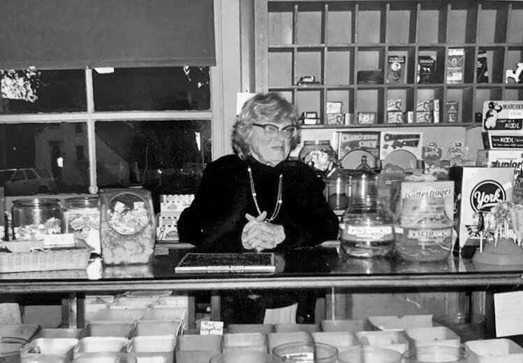 Alice Rice of Floyd’s Candy on Central Street (today J. McLaughlin).  She sold penny candy and comic books in her general store, so she was a legend and a rite of passage for decades of local children growing up in Manchester.  Her son, Fred Rice, was an accomplished gardener, landscape designer, and the face of the North Shore Horticultural Society’s annual plant auction.