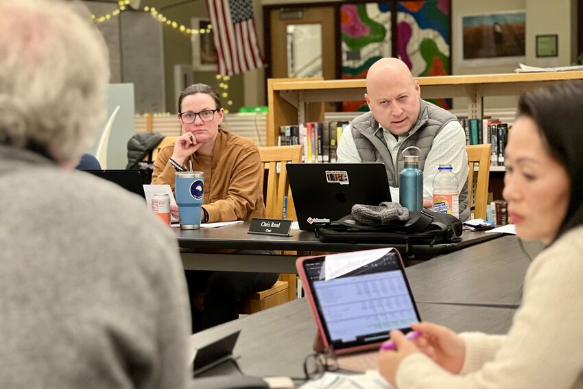 School Committee’s Kate Koch-Sundquist (left) and Chair Christopher Reed (right) focus on options presented by the committee’s Jake Foster. A final budget will be voted on later this month.
