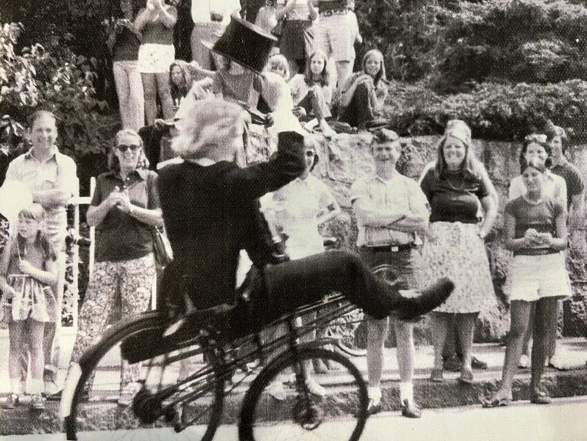 This year, Scott Milne will have “marched” in the Manchester 4th of July Parade with the beloved antique bicycle brigade for 50 years!  This vintage photo shows Milne riding in 1975.