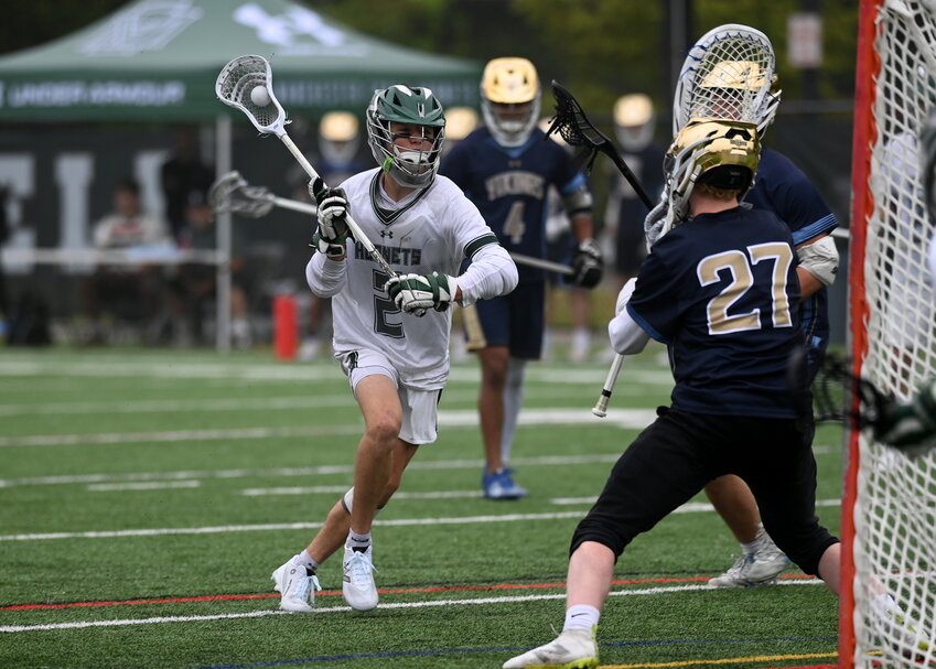 Charlie Thurlow charges the net against the East Bridgewater Vikings during MIAA D4 Round of 32.  The Hornets prevailed 17-4..