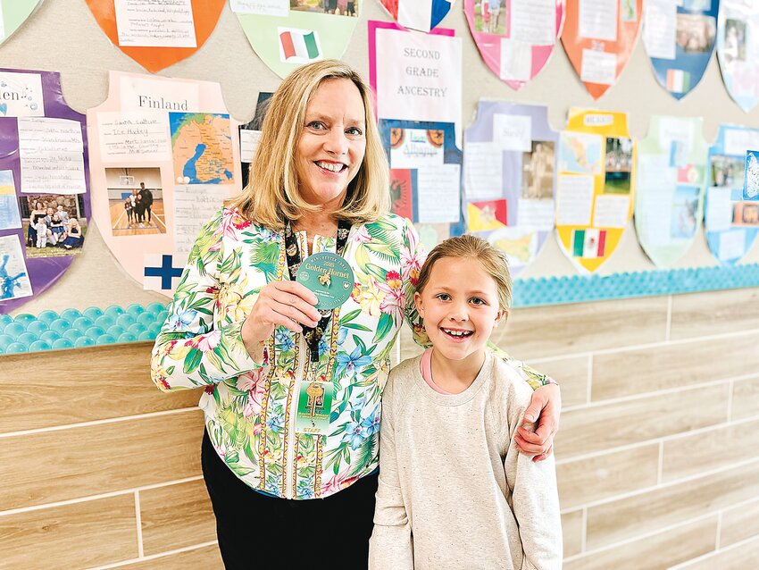 Little Ellie Orr, right, a second grader at Manchester Memorial Elementary School, with her teacher, Susan Gould, this year’s recipient of the Diamond Hornet as part of the Spaulding Education Trust’s recognition program for public school education heroes.
