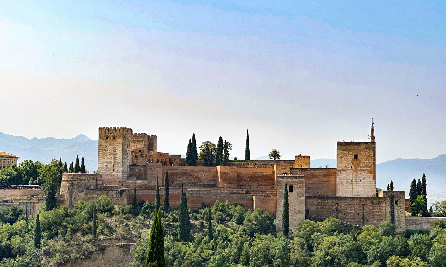 <p><em>The Alhambra in Granada is a Moorish fortress made up of palaces and gardens.  Across the city, at the Mirador de San Nicolás, one can see the complete fortress for great picture opportunities.</em></p>