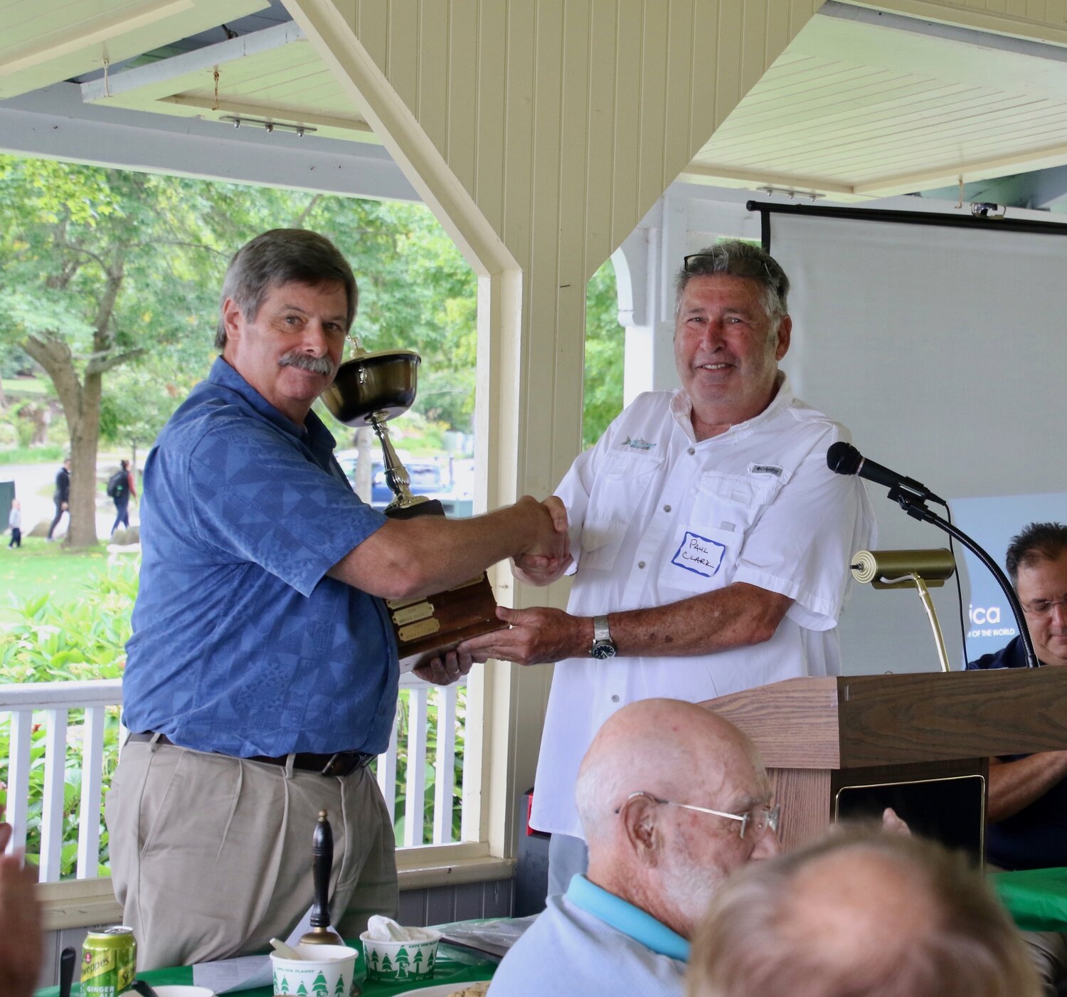 Cricket Assistant Editor Paul Clark, presenting Mike Chapman with the Elder Brethren Slade Eaton Award, the ceremonial cup for community service.