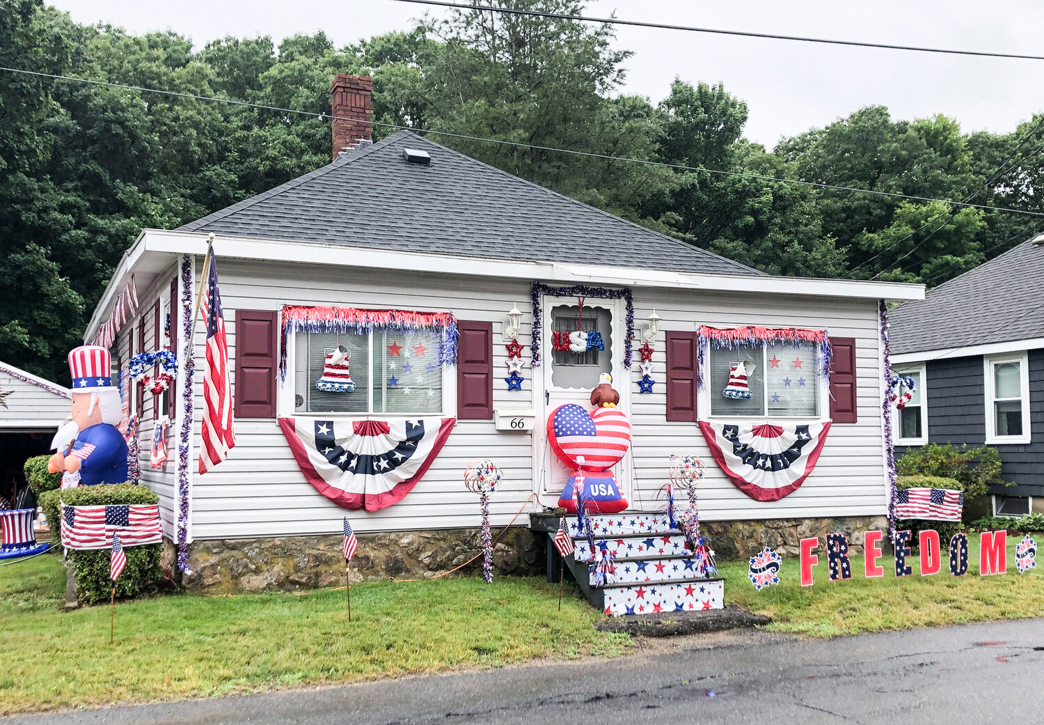 The Powers Family of 66 Pleasant Street: Time and Effort Award (lots of flags covering all sides of the house)