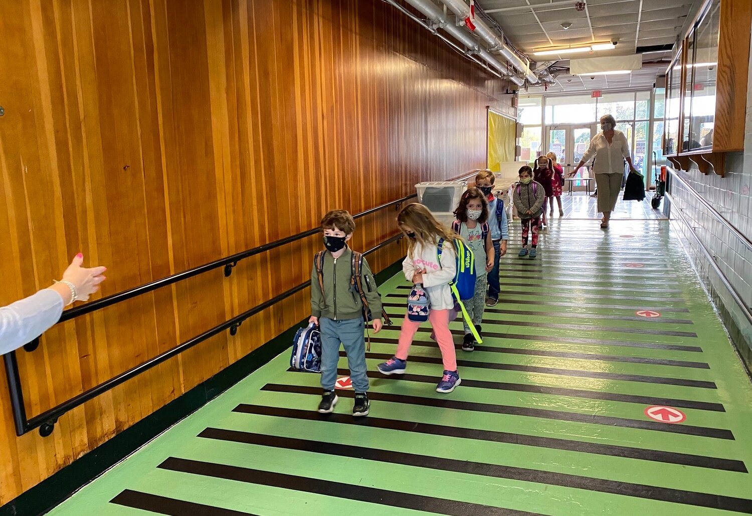 Manchester Essex School Committee last week green lighted a cautious return of the district’s elementary school students to a hybrid school week.  Here, K-2 Memorial Elementary School students are back to a partial in-person learning program this week. (Courtesy Photo)
