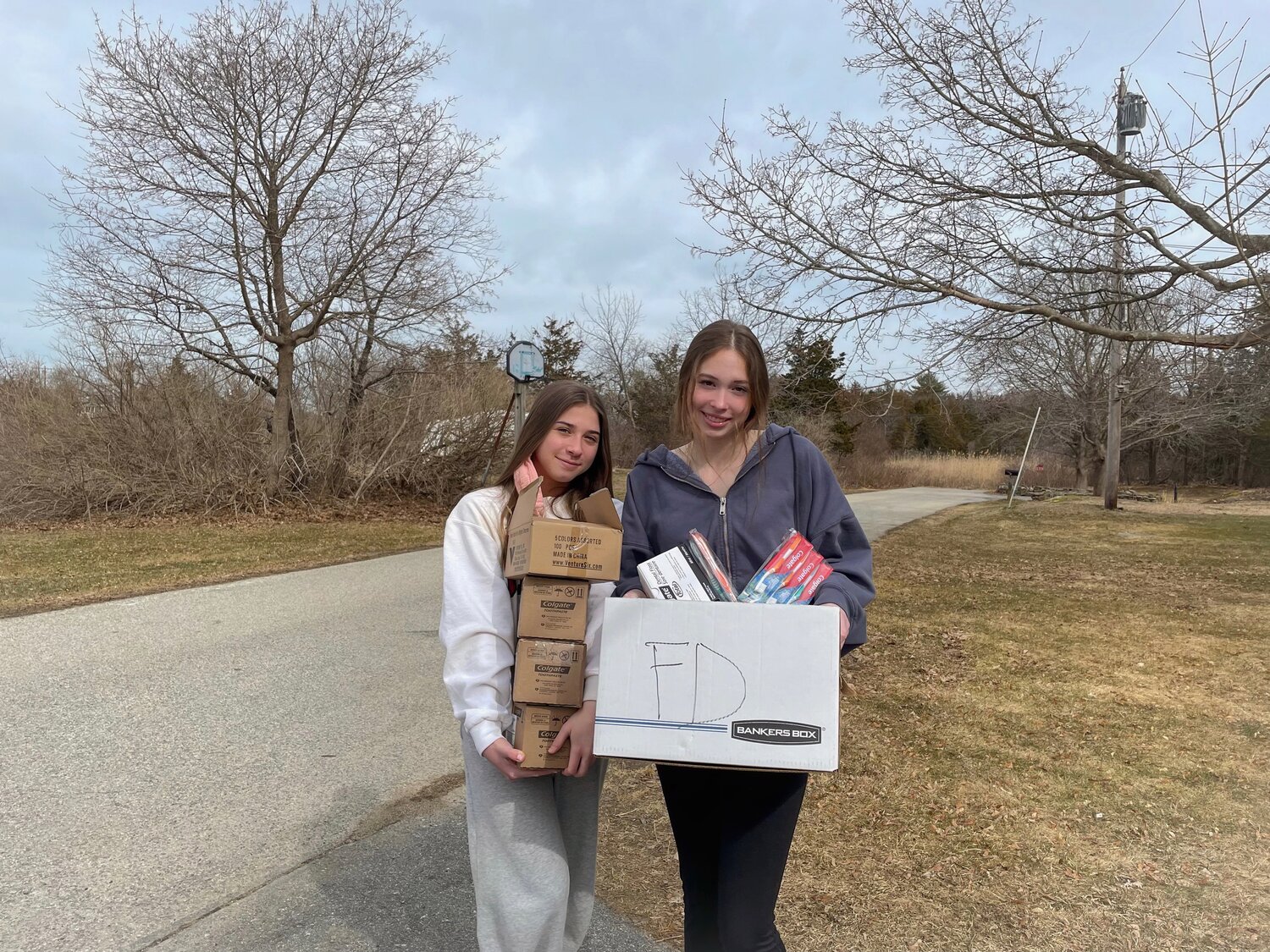 Ava Ricci and Sophie Zalosh, sophomores at Manchester Essex Regional high school fundraising for children and teenagers in the foster care system through Comfort Cases, a nationwide organization.