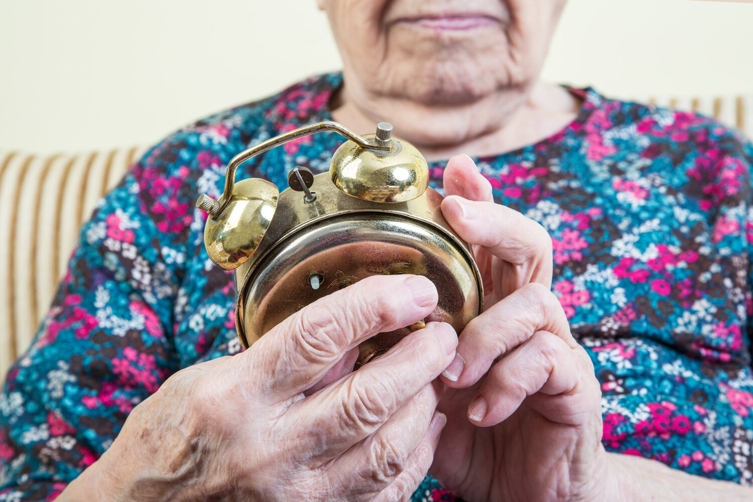 Elderly Woman Winding Clock