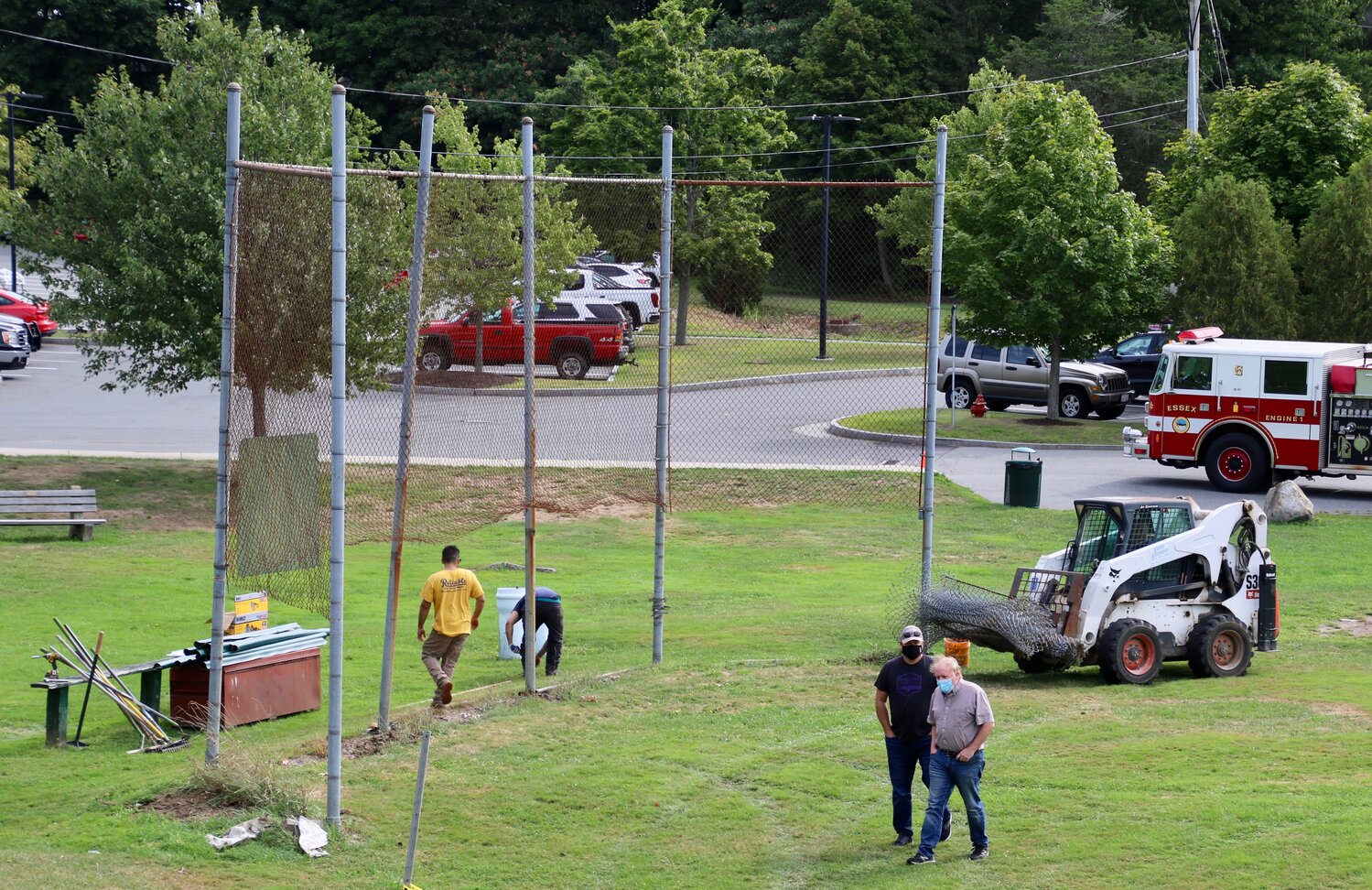 Work starts at Memorial Field under the watchful eyes of Marty Flood (left) and Jim McKenna. 