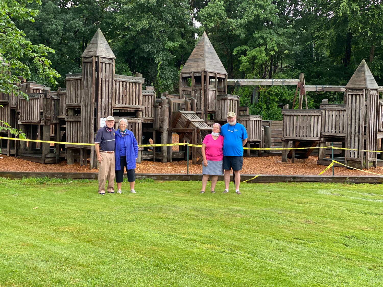 The true originals, Bonnie Bradford (left) and Dawn and Wesley Burnham (at right) pose in front of the cherished Eagle’s Nest Structure they organized to build 33 years ago. 