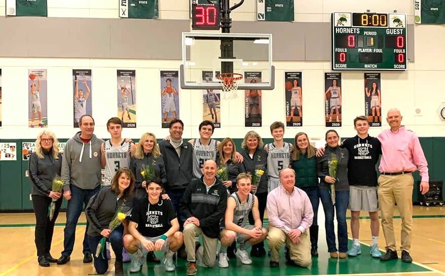 On Thursday, February 13, the Hornets met the Rockport Vikings for NE's Senior Night match. By tradition, during the last scheduled home game the seniors than their parents for the strong support demonstrated over a long basketball season. Banner are hug, balloons are flow and the boys present bouquets of flowers to their parents. Show here in the front row are Mason Paccone and Lars Arntsen, and in the back grow, Ian Taliaferro, Jake Edwards,  Spencer Meek, and Kellen Furst. The boys dominated Rockport 71-38 with high-scorer Kellen Furse draining 39 points. Next up, MIAA tournament time, TBA. 