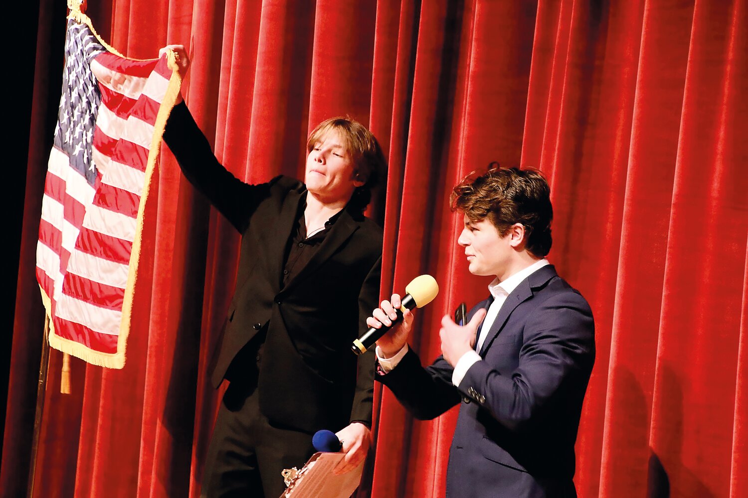 Beckett Walker holds the flag as Quinn Brady sings the National Anthem at Spaulding Education Fund’s Night of the Stars.