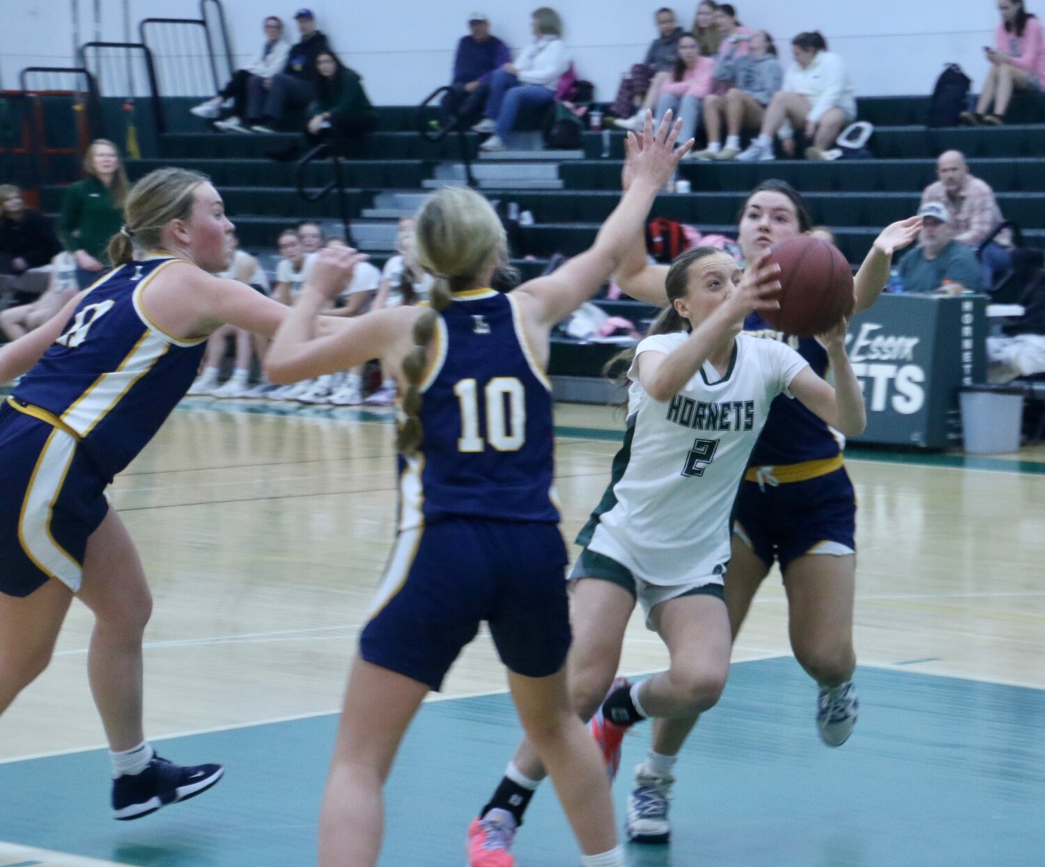 ME Hornet Harper Brooks drives through Lynnfield opponents on the way to the hoop during a rare loss for the home team.  They have only lost two at home and boast a record of 10-4 for the season.