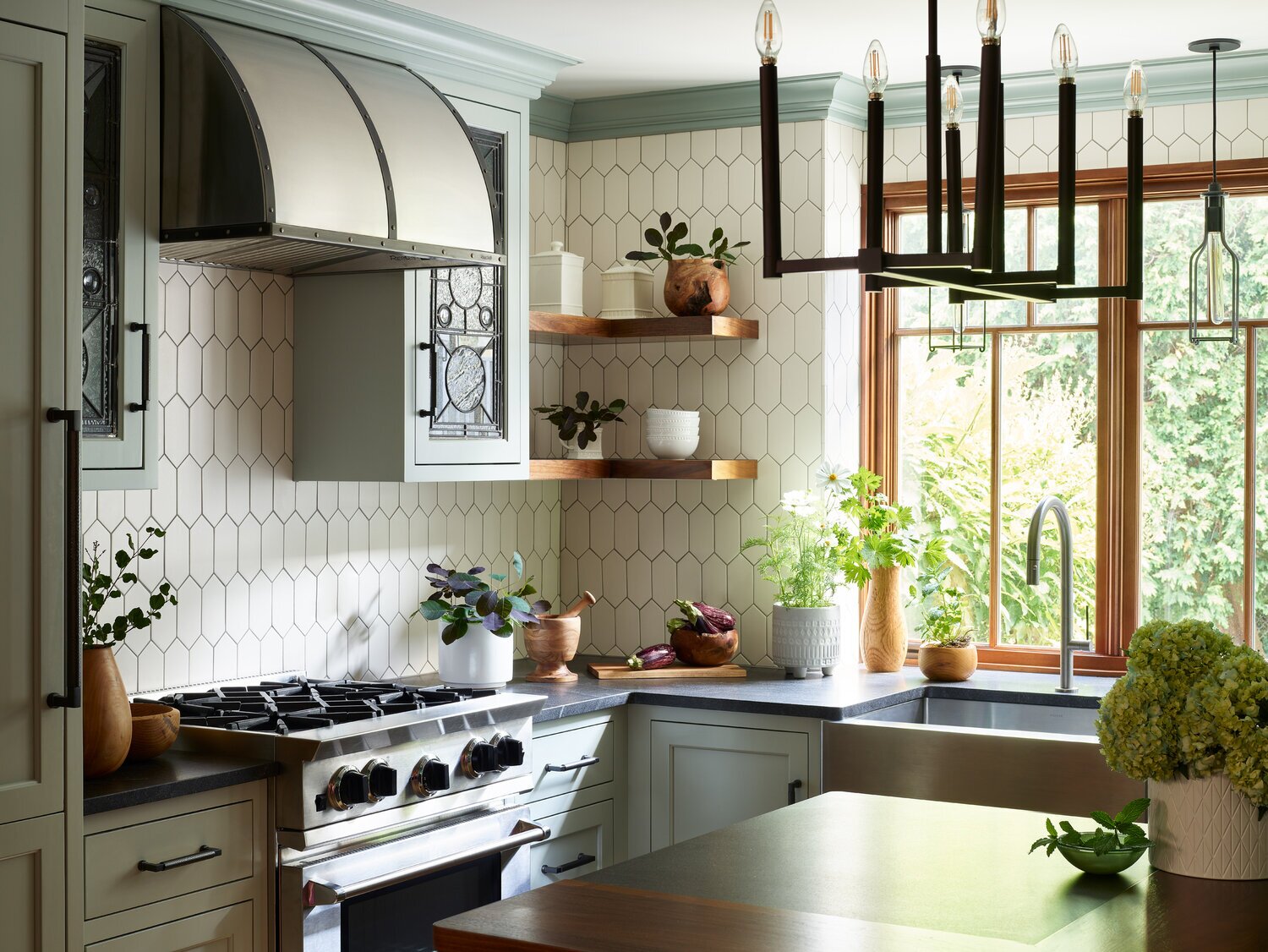Manchester-based interior designer Karen Swanson designed the counter in this Boston kitchen to extend eight inches behind the sink to accommodate plenty of potted plants.