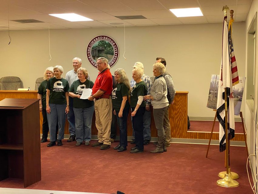 Euharlee Mayor Steve Worthington presents an Arbor Day proclamation to members of the Hoe'n in Euharlee Garden Club at Tuesday evening's public meeting.