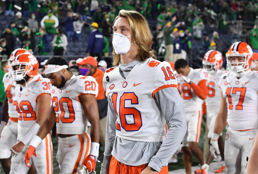 Clemson quarterback Trevor Lawrence (16) leaves the field with his teammates after Clemson lost to Notre Dame, 47-40 in two overtimes, Saturday in South Bend, Indiana.