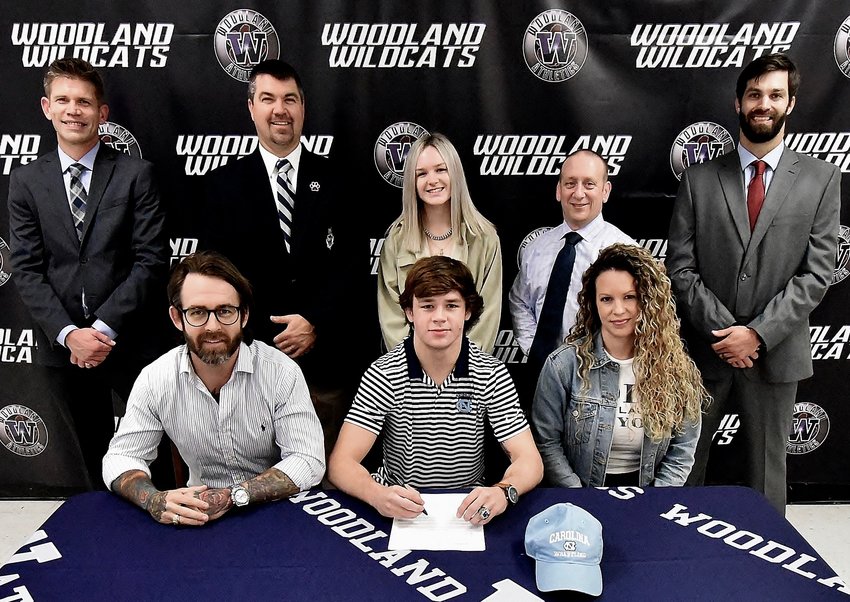Woodland High senior Caden McCrary signed Wednesday to wrestle at the University of North Carolina in Chapel Hill. On hand for the signing were, from left, front row: Jason McCrary, father; Melanie McCrary, mother; back row, David Stephenson, WHS principal; John Howard, WHS athletic director; Anna McCrary, sister; Adrian Tramutola, WHS head wrestling coach; and Ross Cravens, WHS assistant wrestling coach.