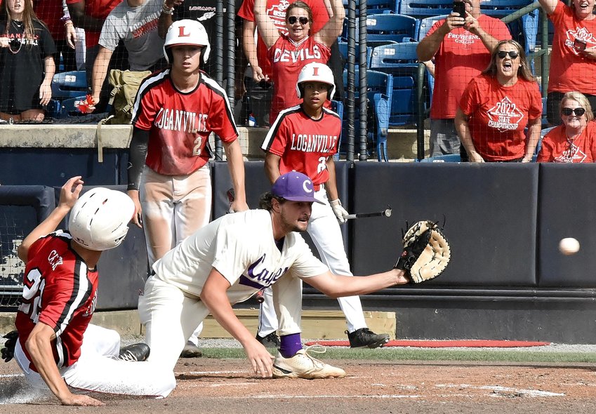 Cartersville senior Drew Rothschild awaits a throw, as a Loganville runner slides in safely to home plate, during the second inning of Game 3 in the Class 5A state championship series May 24 at AdventHealth Stadium.