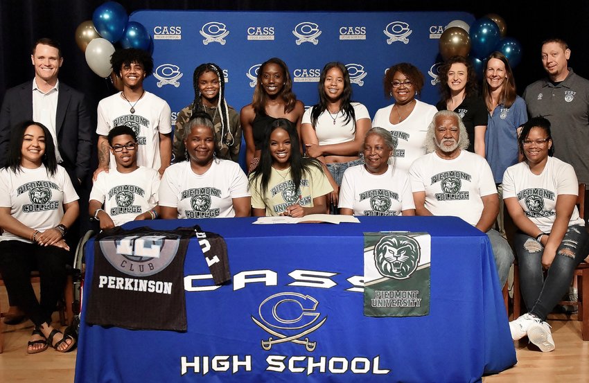 Cass High senior Kya Perkinson signed to play volleyball at Piedmont College in Demorest. On hand for the signing were, from left, front row: Shana Perkinson, aunt; Daydrien Perkinson, cousin; Shelby Williams, mother; Linda Perkinson, grandmother; Nate Perkinson, grandfather; Brittany Williams, godmother; back row, Steve Revard, CHS principal; Jonathan Pritchett, cousin; Bri'nya Jones, friend; London Moultrie, teammate; Dasja Sims, friend; Carla Price, aunt; Dani Bishop, club coach; Jessica Walker, Fury volleyball club director; and Erik Walker, Fury volleyball club director.
