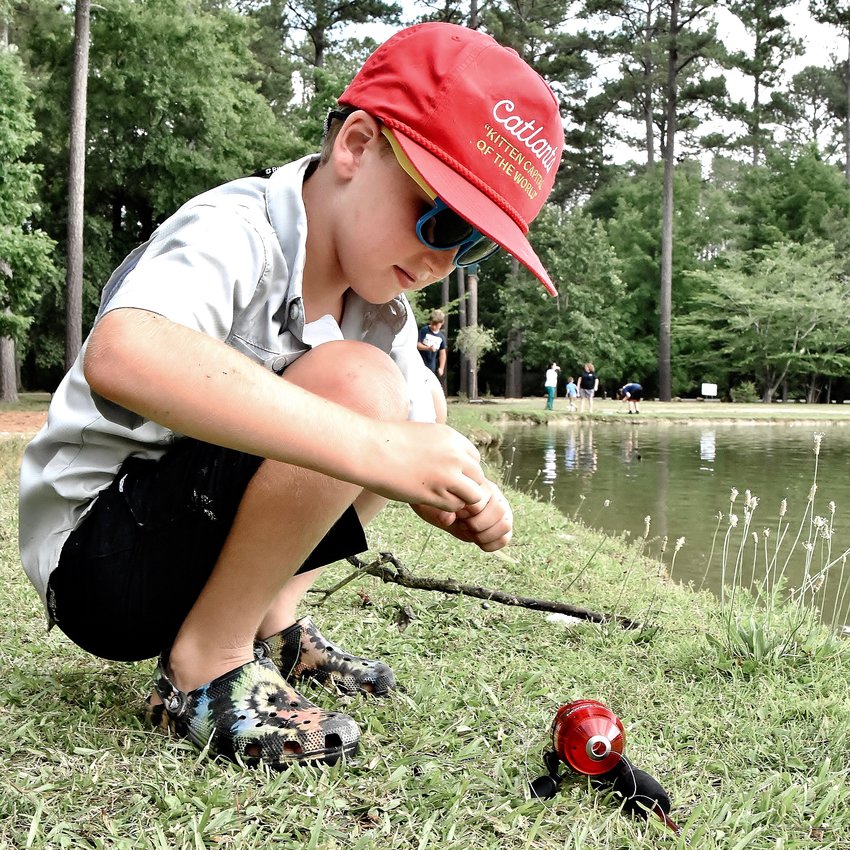 Nine-year-old Jameson Latta of Cartersville prepares his line at Youth Fishing Day at Dellinger Park Lake June 6. The event was presented by the Cartersville Parks and Recreation Department.