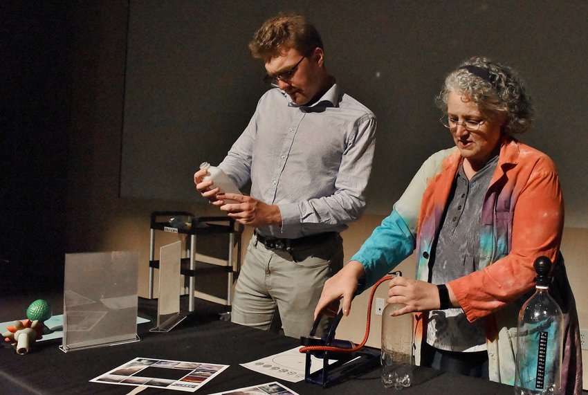 Tellus Science Museum Marketing Associate Jordan Lentz, left, and General Science Program Manager Wendy Hayes demonstrate the Cloud in a Bottle activity, which will be a key part of the Wild About Weather day July 16.