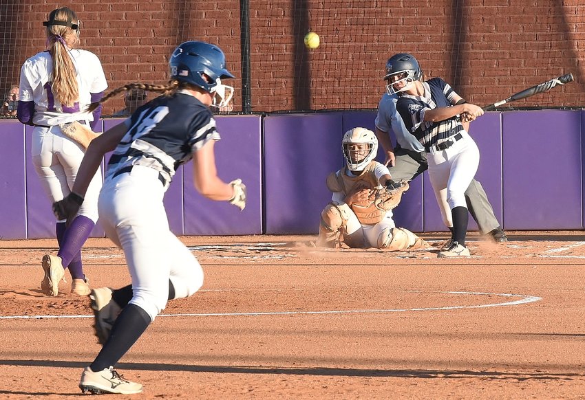 Woodland's Peyton Dorn makes contact as Bailey Sakacsi takes off for third during Cartersville's 6-3 win on Tuesday.