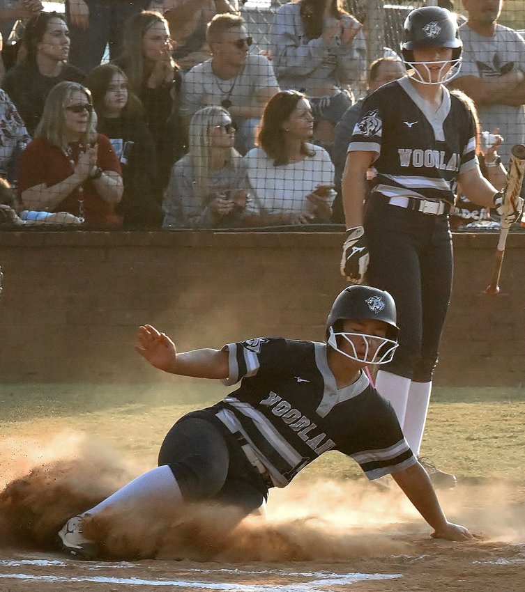Woodland's Mackenzie Araya slides into home during the Lady Wildcats 4-1 win over Cass. The win locked up third place in Region 7-5A and Cass is fourth.